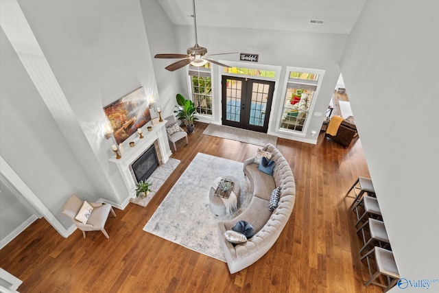68 Natures Ridge Way, Huntsville, AL 35803 - living room featuring a fireplace with flush hearth, french doors, a ceiling fan, wood finished floors, and baseboards