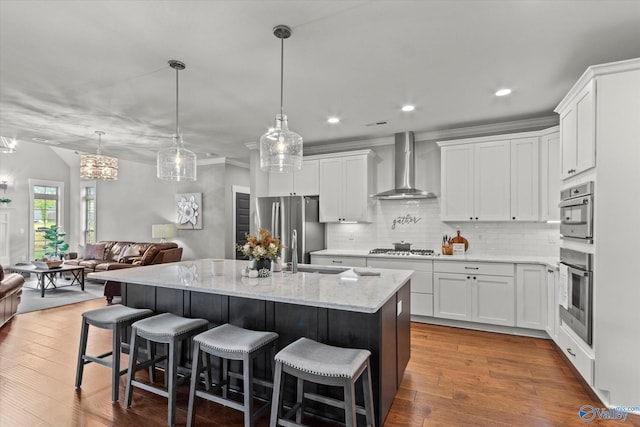 68 Natures Ridge Way, Huntsville, AL 35803 - kitchen with wall chimney range hood, freestanding refrigerator, open floor plan, tasteful backsplash, and a kitchen island