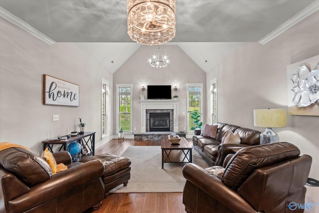 68 Natures Ridge Way, Huntsville, AL 35803 - living room featuring a chandelier, wood finished floors, lofted ceiling, and a glass covered fireplace