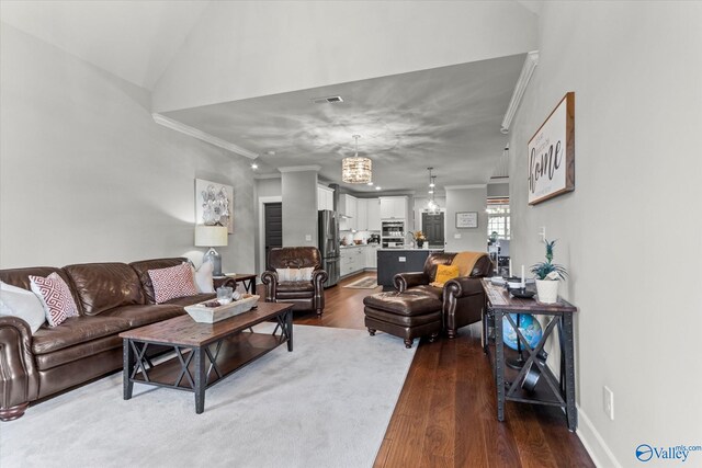 68 Natures Ridge Way, Huntsville, AL 35803 - living room with ornamental molding, dark wood-type flooring, and a chandelier