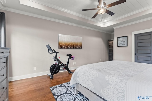 68 Natures Ridge Way, Huntsville, AL 35803 - bedroom with wood finished floors, a tray ceiling, baseboards, ornamental molding, and a ceiling fan