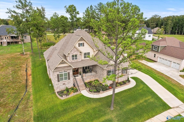 68 Natures Ridge Way, Huntsville, AL 35803 - view of front facade with stone siding, a porch, a front yard, and a garage