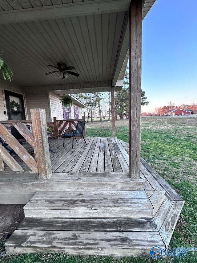 deck featuring a lawn and a ceiling fan