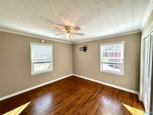 unfurnished bedroom with dark wood-type flooring, crown molding, a textured ceiling, and ceiling fan