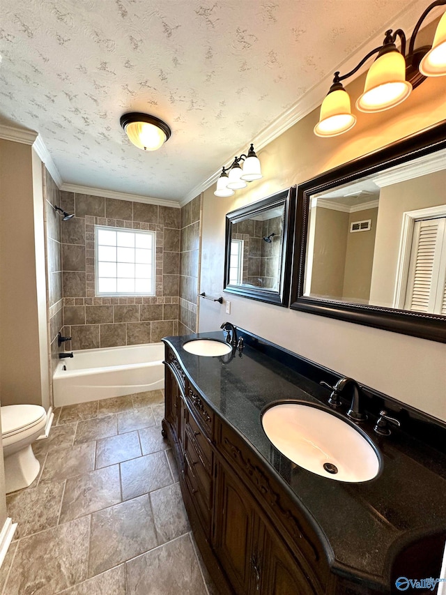 full bathroom featuring vanity, crown molding, tiled shower / bath combo, and toilet