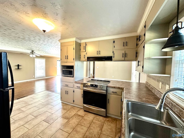 kitchen featuring cream cabinets, light hardwood / wood-style flooring, stainless steel appliances, sink, and a textured ceiling