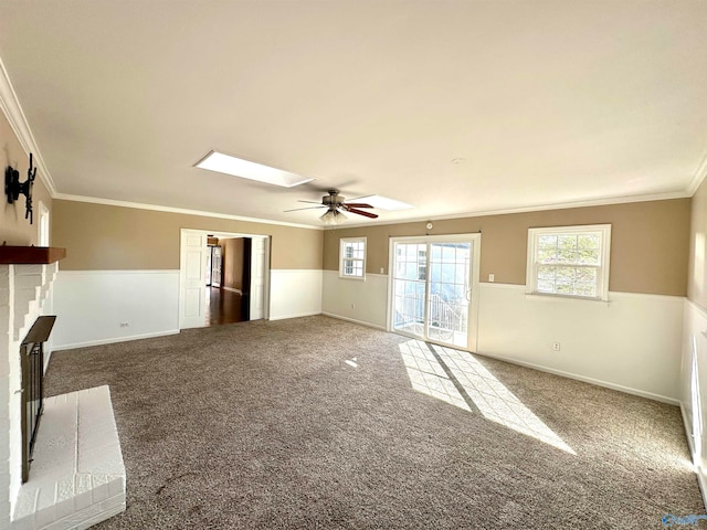 unfurnished living room featuring crown molding, carpet flooring, and ceiling fan