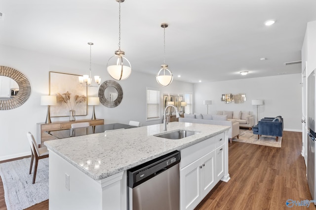 kitchen featuring sink, wood-type flooring, dishwasher, white cabinetry, and hanging light fixtures