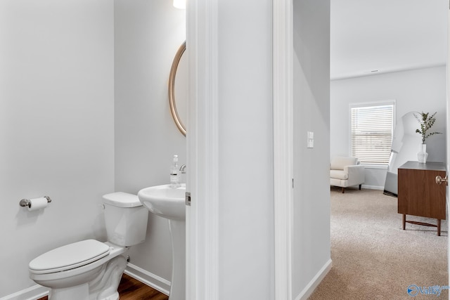 bathroom with wood-type flooring and toilet