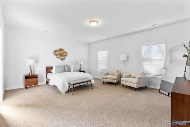 bedroom featuring light colored carpet, visible vents, and baseboards