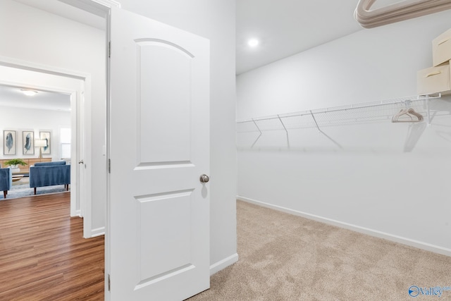 spacious closet with light hardwood / wood-style flooring