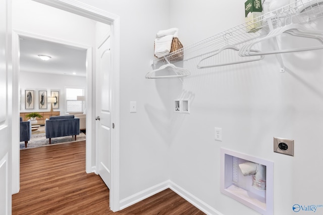 laundry room with hookup for a washing machine, electric dryer hookup, wood finished floors, laundry area, and baseboards