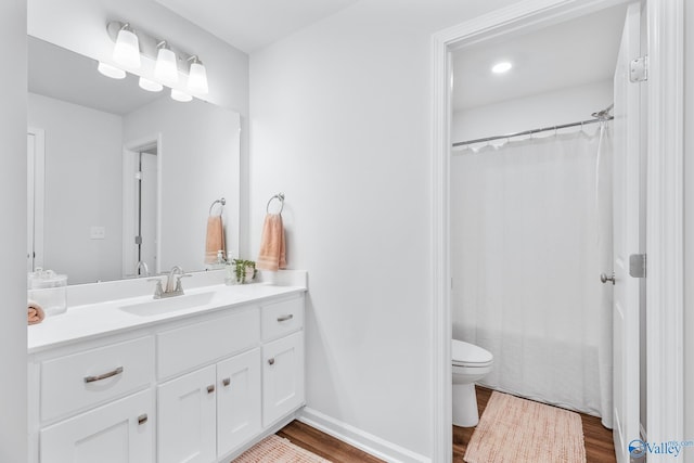 full bath featuring toilet, a shower with curtain, wood finished floors, and vanity