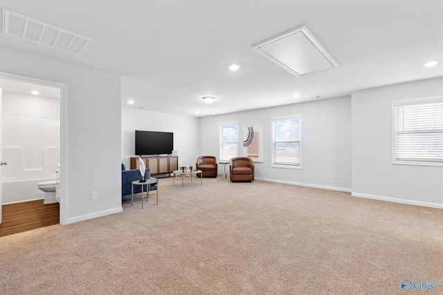 living area featuring light carpet