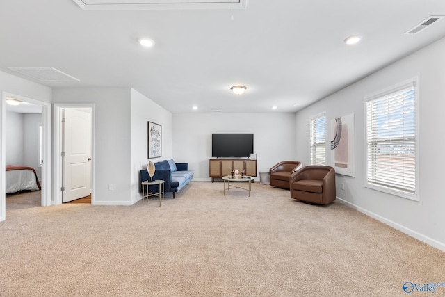 living area with light carpet, attic access, visible vents, baseboards, and recessed lighting