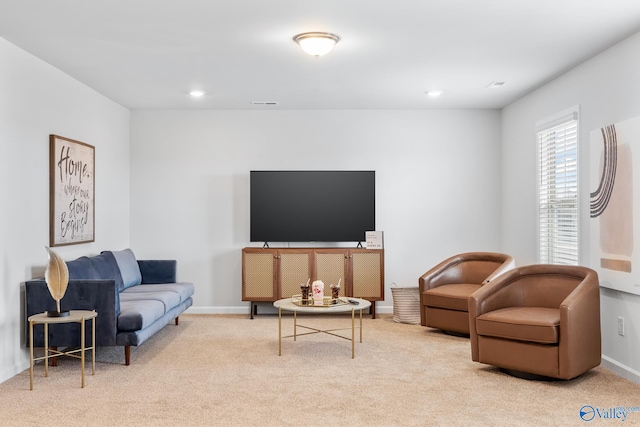 living area featuring recessed lighting, baseboards, and light colored carpet