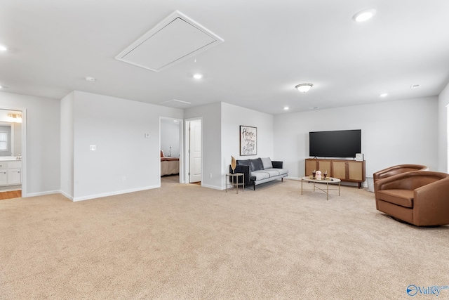 sitting room with attic access, recessed lighting, light colored carpet, and baseboards