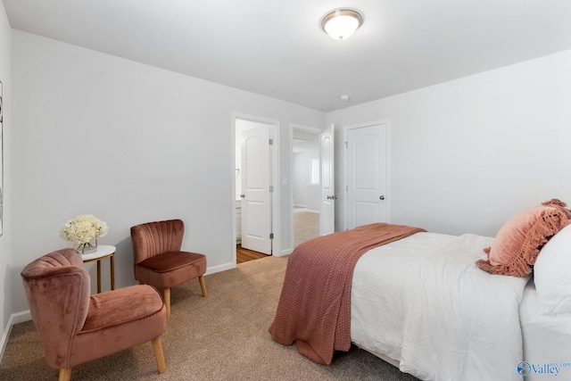 bedroom with baseboards and light colored carpet