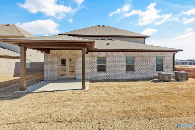 back of house featuring a patio area, central air condition unit, and a yard