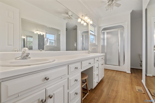 bathroom with crown molding, a ceiling fan, and a sink