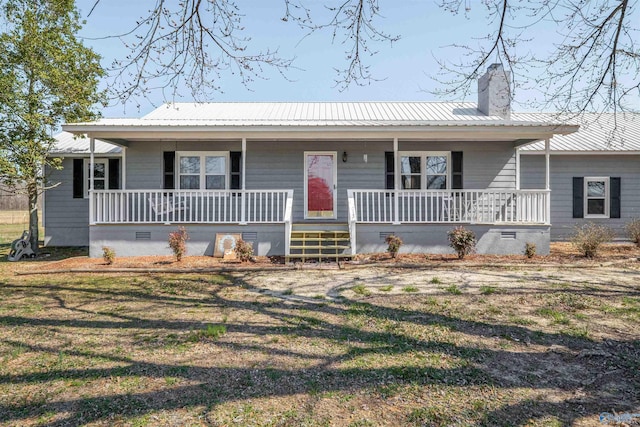 view of front facade featuring crawl space, covered porch, and metal roof