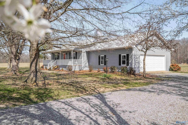 ranch-style house featuring covered porch, driveway, and an attached garage