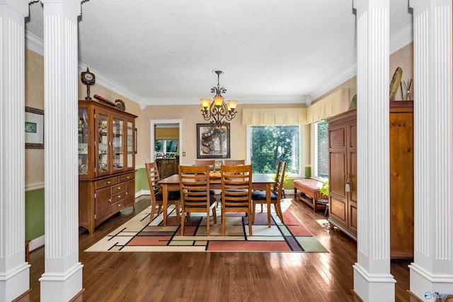 dining space with ornate columns, ornamental molding, and dark hardwood / wood-style floors