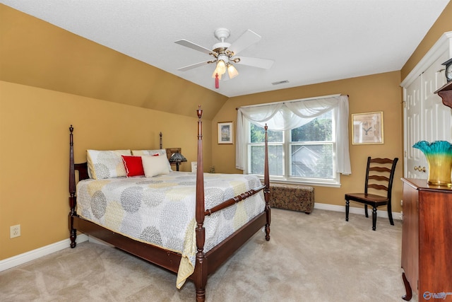 carpeted bedroom featuring lofted ceiling and ceiling fan