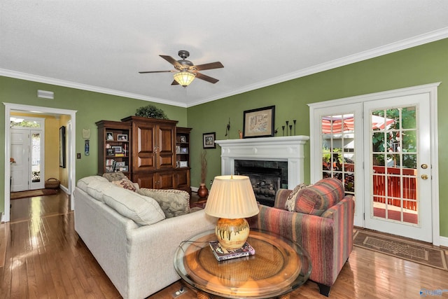 living room featuring crown molding and plenty of natural light