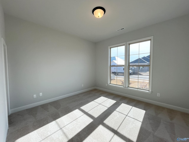 carpeted empty room featuring plenty of natural light