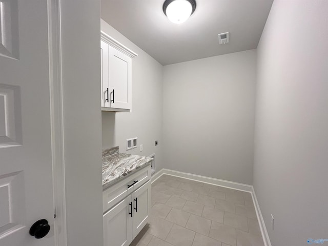 washroom with cabinets, hookup for a washing machine, light tile patterned floors, and electric dryer hookup