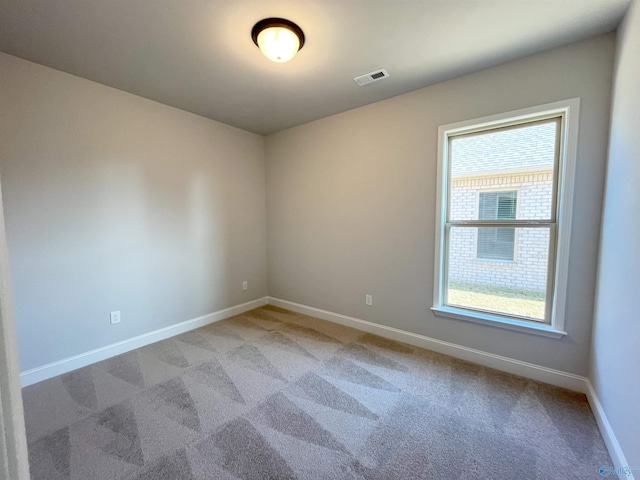 empty room featuring carpet and plenty of natural light