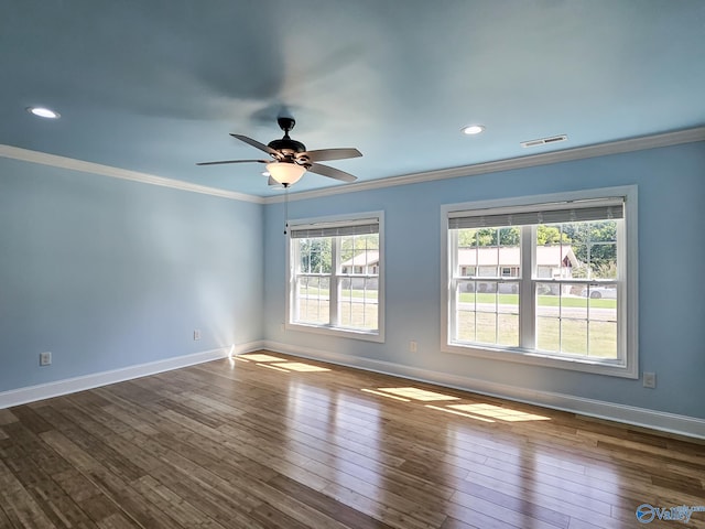 spare room with wood-type flooring, ornamental molding, and ceiling fan