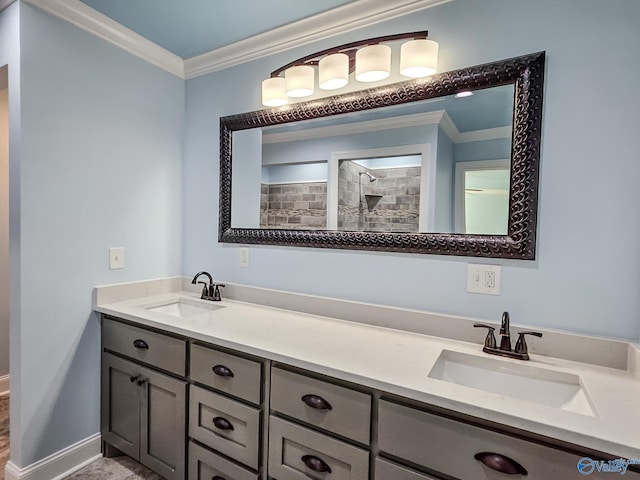 bathroom with vanity, crown molding, and tiled shower