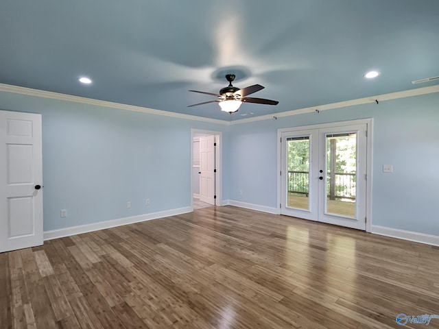 spare room featuring french doors, crown molding, hardwood / wood-style floors, and ceiling fan