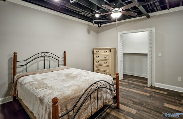 bedroom with ornamental molding, dark hardwood / wood-style flooring, and ceiling fan