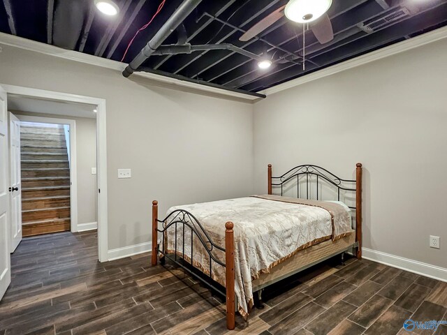 bedroom with ceiling fan, dark hardwood / wood-style floors, and crown molding