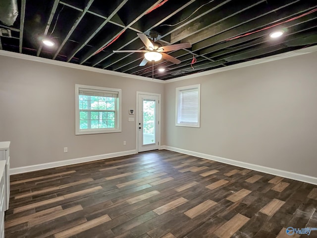 interior space with ceiling fan, dark hardwood / wood-style floors, and crown molding