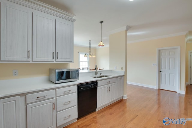 kitchen featuring stainless steel microwave, dishwasher, light countertops, light wood-style flooring, and a sink