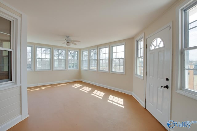 unfurnished sunroom featuring ceiling fan