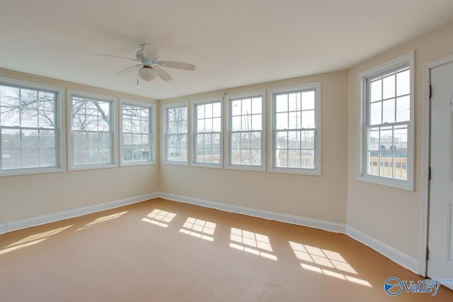 unfurnished sunroom with a ceiling fan