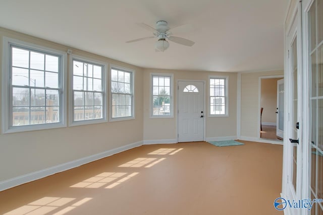 entryway with a ceiling fan and baseboards