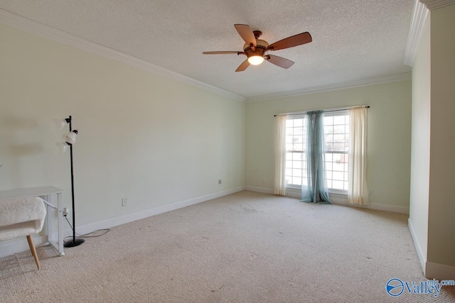 carpeted spare room with crown molding, a ceiling fan, baseboards, and a textured ceiling