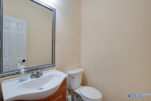 bathroom featuring toilet and vanity