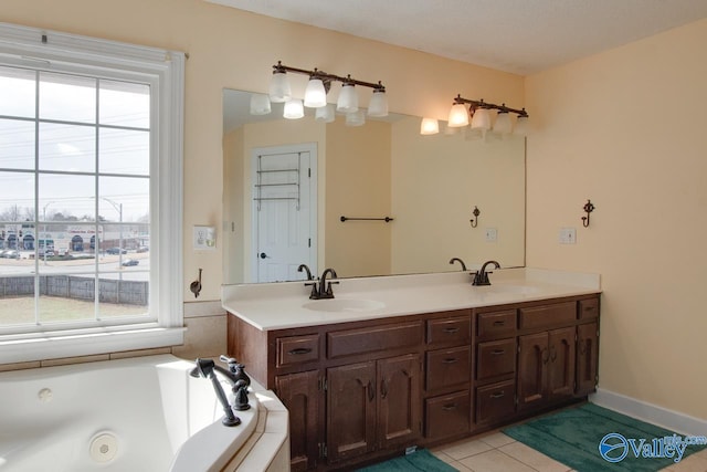 bathroom with a wealth of natural light, tile patterned flooring, and a sink