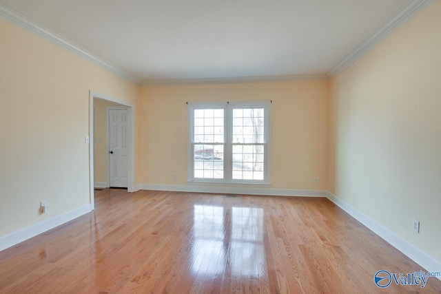 unfurnished room with light wood-type flooring, baseboards, and crown molding