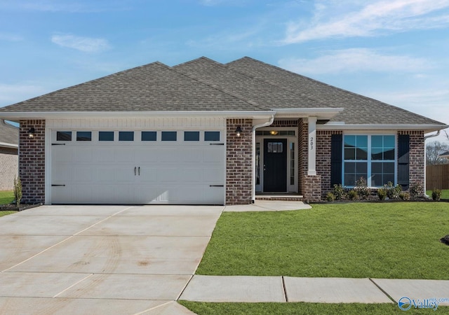 view of front of house featuring a garage and a front lawn