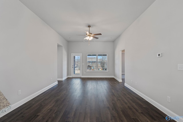 unfurnished living room featuring dark hardwood / wood-style floors and ceiling fan