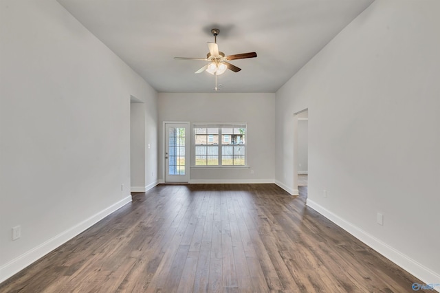 unfurnished room featuring dark wood-type flooring and ceiling fan