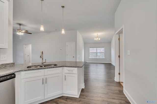 kitchen featuring sink, dishwasher, white cabinetry, stone countertops, and decorative light fixtures